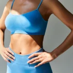 A woman in a blue sports bra and shorts, illustrating the concept of sustaining weight loss results post-medical intervention.
